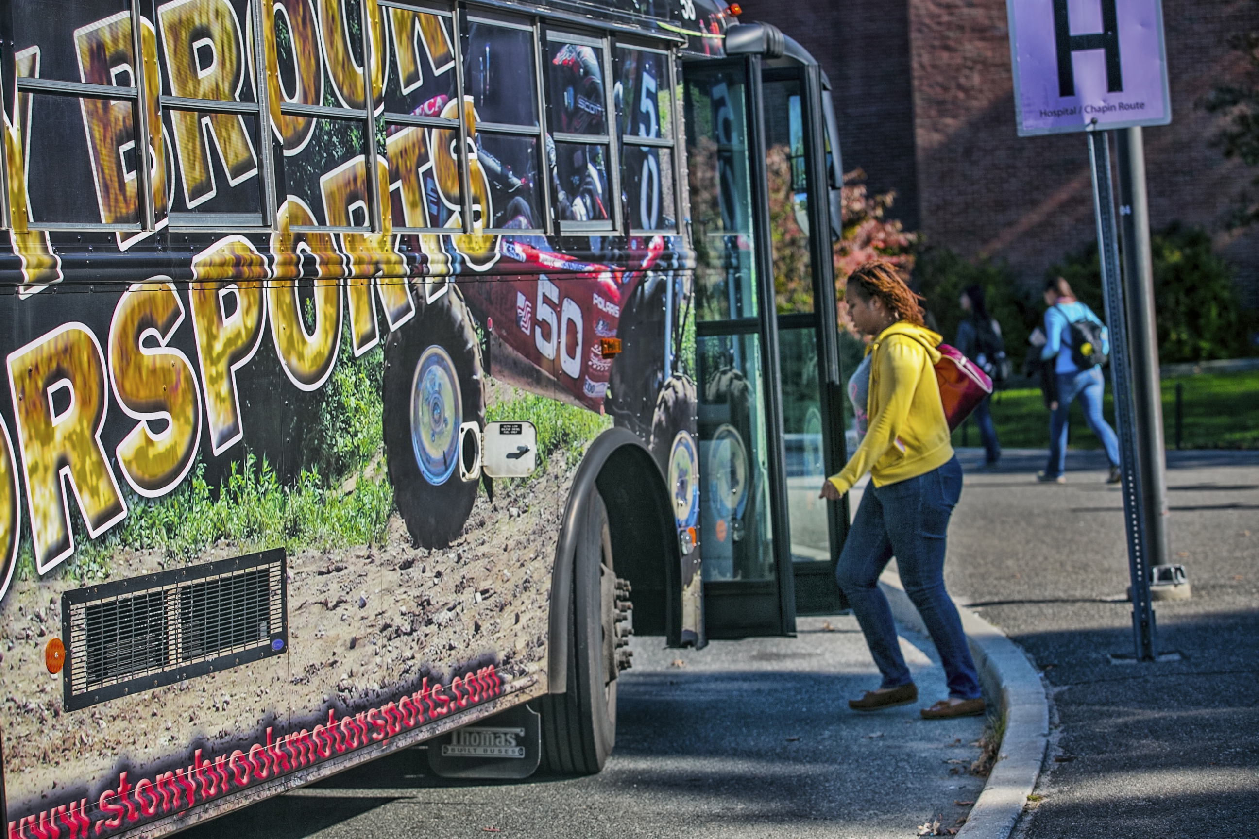 SBU student getting on campus bus